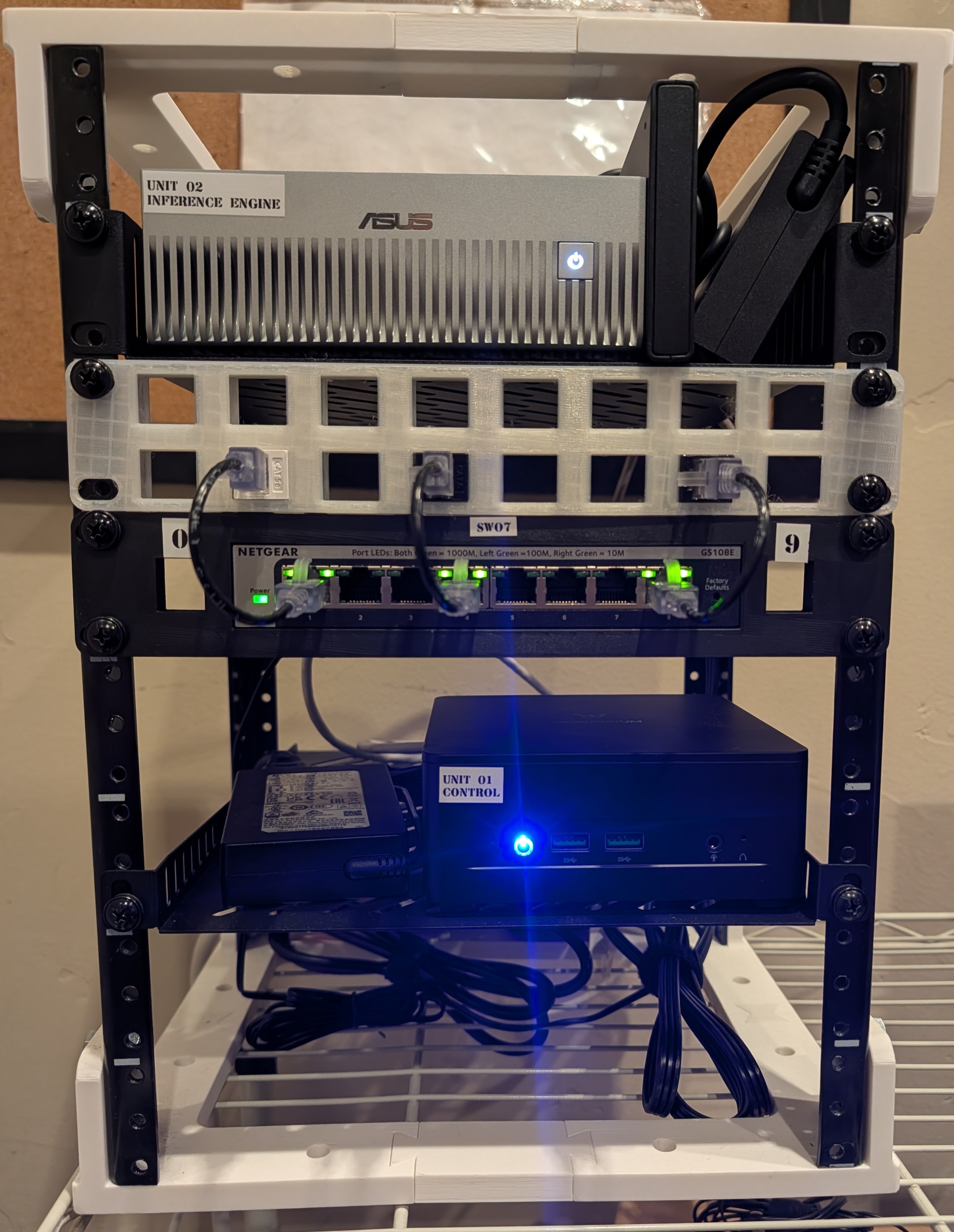 A 10-inch minirack housing an ASUS Ascent GX10, custom patch panel, Netgear switch, and a local compute node for Suitcase AI.