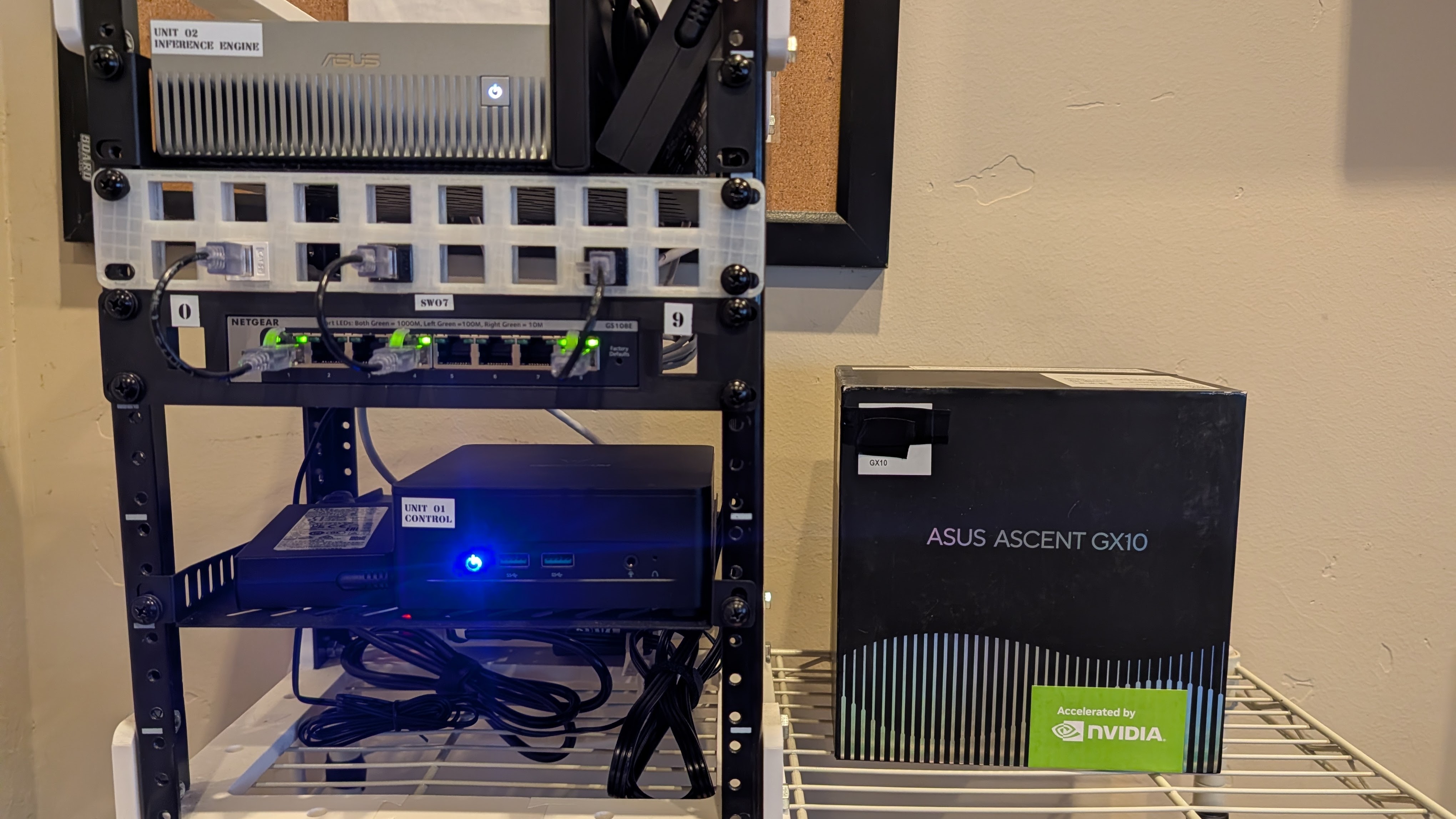 The Suitcase AI 10-inch minirack with Unit 01 (control) and Unit 02 (ASUS Ascent GX10 inference), sitting next to the retail ASUS Ascent GX10 box.